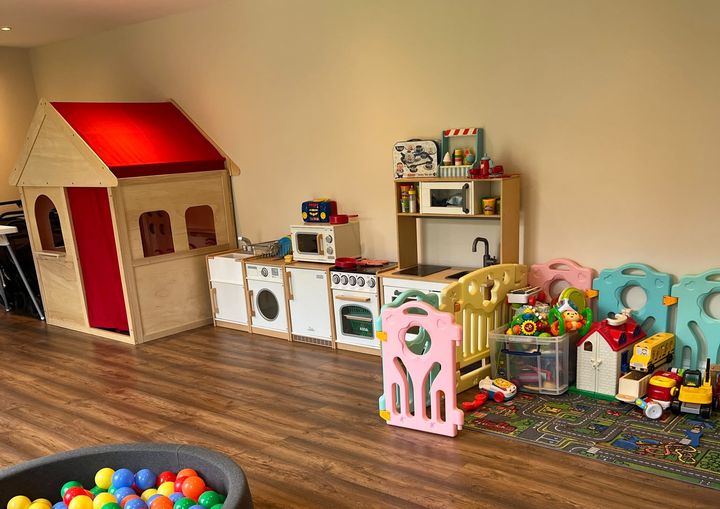 Wooden playhouse and soft-play den in the playroom