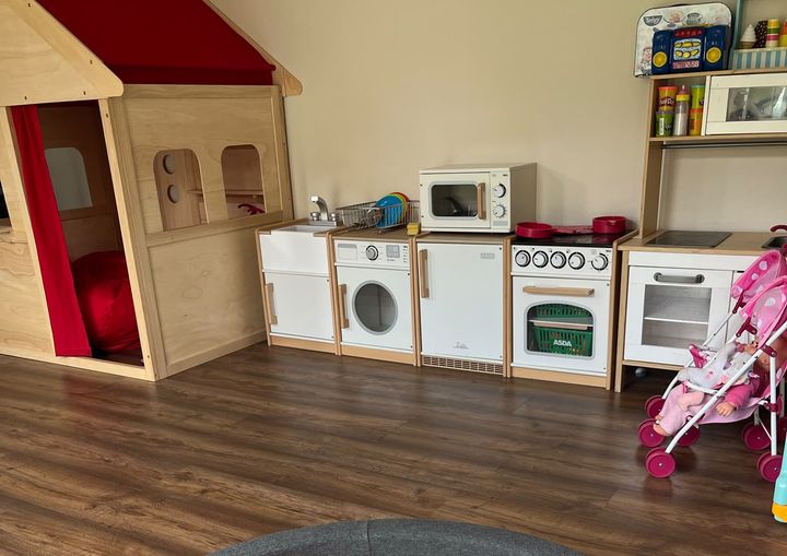 Wooden play kitchen and toys set up in the playroom